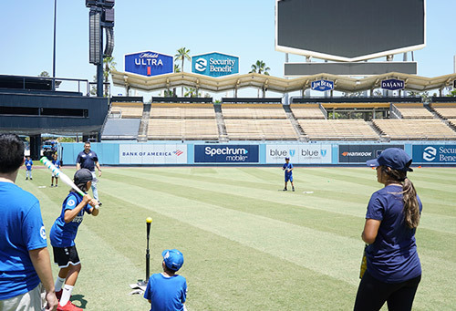 Children playing baseball and holding a bat
